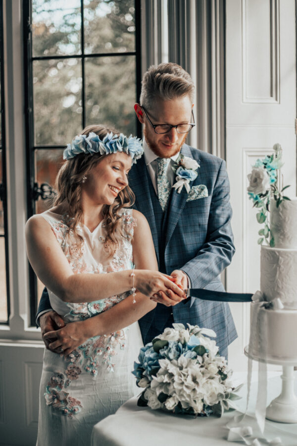 Blue wedding theme, cake cutting, floral head wreath